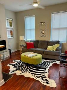 a living room with a couch and a zebra rug at CUTE & COZY/TQL stadium/ Findlay Market/Brewery in Cincinnati