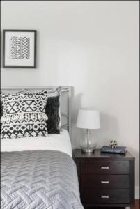 a bedroom with a bed and a table with a lamp at CUTE & COZY/TQL stadium/ Findlay Market/Brewery in Cincinnati