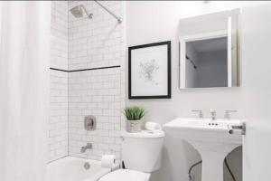 a white bathroom with a toilet and a sink at CUTE & COZY/TQL stadium/ Findlay Market/Brewery in Cincinnati
