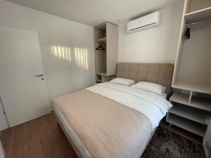 a small bedroom with a bed and a closet at Residence 33 in Sarajevo