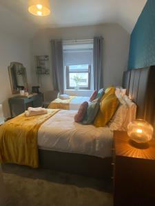 a bedroom with two beds and a window at Woodquay House in Galway