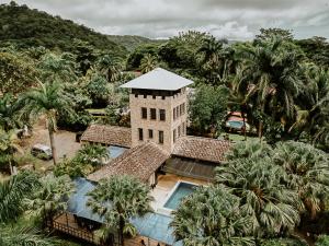 an aerial view of a building with a swimming pool at Castillo Tambor Resort & Restaurant in Tambor