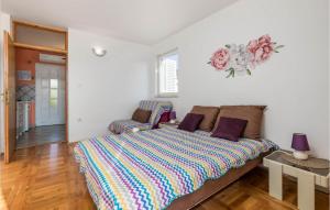 a living room with a bed and a couch at Gorgeous Apartment In Stara Novalja With Kitchenette in Stara Novalja