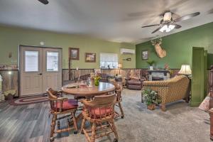 a living room with green walls and a table and chairs at Cozy Goshen Farm Studio Ideal for Extended Stays! in Goshen