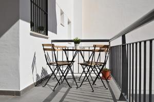 a table and two chairs on a balcony at Alojamiento Alcantara in Alora