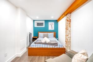 1 dormitorio pequeño con 1 cama y 1 sofá en Spacious 1BR Suite just minutes from High Park en Toronto
