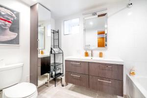 a bathroom with a toilet and a sink at Spacious 1BR Suite just minutes from High Park in Toronto