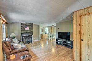 a living room with a couch and a television at Suwannee Riverfront Home Grill, Near Springs in Branford
