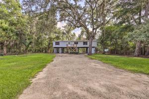 a house on the side of a dirt road at Suwannee Riverfront Home Grill, Near Springs in Branford