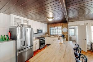 a kitchen with a wooden ceiling and a wooden table at Bear Den in Oakhurst