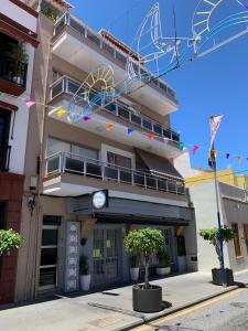 a building with a balcony and a sign on it at Apartamento a 50 metros de la Plaza del Charco, Puerto de la Cruz in Puerto de la Cruz