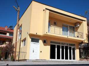 a house with a balcony on the side of it at Cavleski apartment in Prilep
