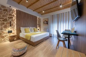 a bedroom with a bed and a desk and a television at A&N Athens Luxury Apartments - Akadimou in Athens