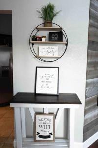 a table with a mirror and a plant on it at Modern 3BR Home, Saltwater Pool, Fenced Yard in Spring Hill