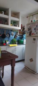 a kitchen with a refrigerator and a table in it at LA CASA DE CLAU in Sarandí