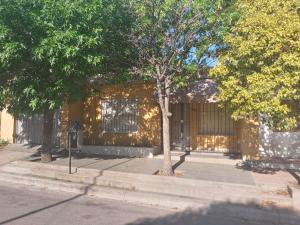 a yellow building with a tree in front of it at Casa Marques in Santa Rosa