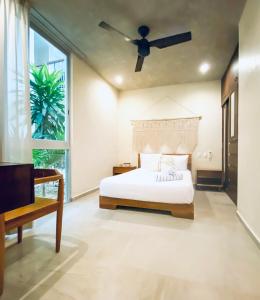 a bedroom with a bed and a ceiling fan at Casa Azul 2 BedBath in Tulum
