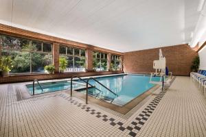 a swimming pool in a large building with a pool at Best Western Grand Victorian Inn in Sayre