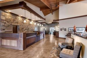 a lobby with a bar and a stone wall at Best Western Plus Cedar City in Cedar City