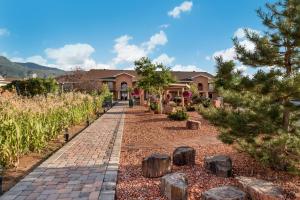 a brick walkway in front of a house with trees at Best Western Plus Cedar City in Cedar City