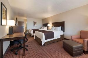a hotel room with two beds and a desk at Best Western Plus Cedar City in Cedar City