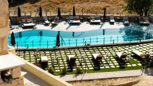 an overhead view of a large swimming pool with chairs at MDC Cave Hotel Cappadocia in Urgup