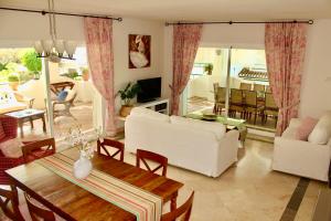 a living room with a white couch and a table at Apartment in El Presidente Beach Side New Golden Mile in Estepona