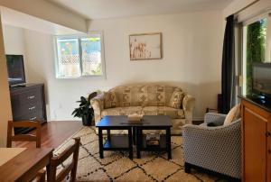 a living room with a couch and a table at Valleyview in Courtenay