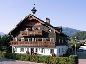 a large wooden house with flowers on the balcony at Illusion in Flachau