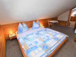 a bedroom with a large bed with blue pillows at Illusion in Flachau