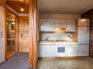 a kitchen with white cabinets and a sink at Illusion in Flachau