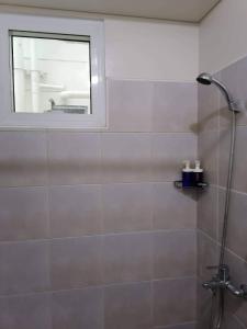 a bathroom with a shower with a window at Celadon Tower- Studio with balcony near SM San Lazaro in Manila +13 photos