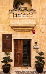 a building with a balcony with flowers on it at The Heritage Boutique Accommodation in Rabat