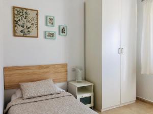 a bedroom with a bed and a white cabinet at Coco in Costa Calma