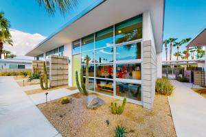 a large white building with large windows and cactus at Cerritos Style Permit #48864 in Palm Springs