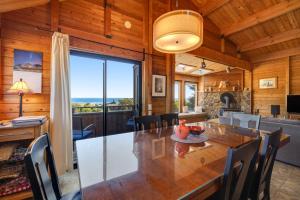 a dining room with a large table and a large window at Shell Beach in Sea Ranch