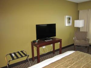 a hotel room with a bed and a television on a table at Inn on the Harbour in Prince Rupert