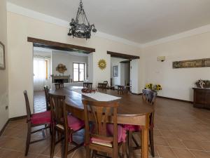 a dining room and living room with a table and chairs at Private villa with swimming pool in the heart of Umbria in Bevagna