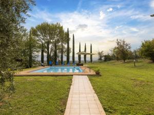 a swimming pool in the middle of a grassy field at Private villa with swimming pool in the heart of Umbria in Bevagna