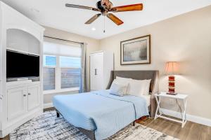 a bedroom with a bed and a ceiling fan at Salt & Light in St. Augustine