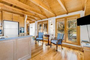 a kitchen with wooden ceilings and a table and chairs at The Potato House in Banner Elk