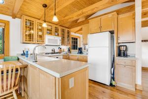 a kitchen with a white refrigerator and wooden cabinets at The Potato House in Banner Elk