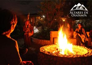 a group of people sitting around a fire pit at Altares de Oxapampa in Oxapampa