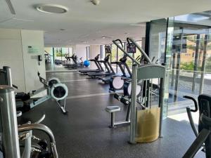 a gym with a row of treadmills and machines at Sub Penthouse Oracle 46th floor - GC Getaways in Gold Coast