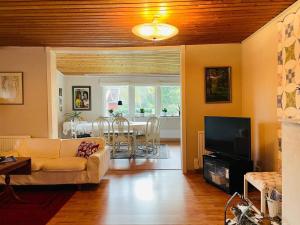 a living room with a couch and a dining room at 5 person holiday home in MÖLLTORP-By Traum in Mölltorp