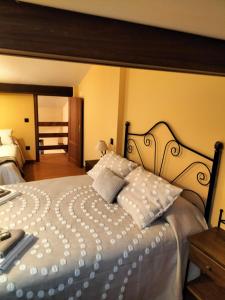 ein Schlafzimmer mit einem großen weißen Bett mit weißen Kissen in der Unterkunft Casita Merrick in Arenas de San Pedro