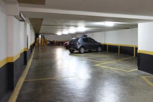 a parking garage with a car parked in it at Mengo Palace Hotel in Rio de Janeiro