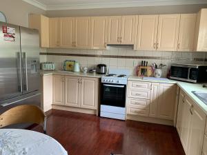 a kitchen with white cabinets and a stove top oven at Almaden Country Rooms in Almaden