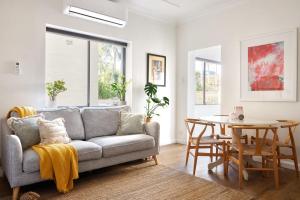 a living room with a couch and a table at Manly Cosy Retreat - Short walk to beach in Sydney