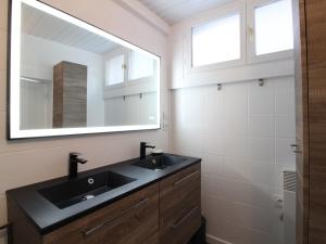 a bathroom with a black sink and a mirror at Maison Confortable à La Bourboule, 130m², Jardin, Proche Centre et Thermes - FR-1-608-237 in La Bourboule +9 photos